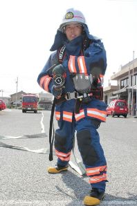 ７キロの防火衣と１２キロの呼吸器を身に着け、ホースの延長訓練をする中原さん＝一宮市の木曽川消防署で