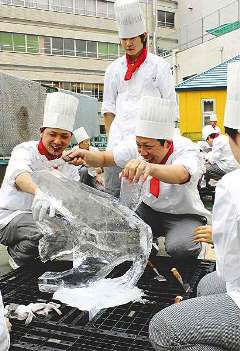 慎重に氷を削る生徒たち＝津市の三重調理専門学校で