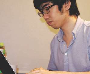 自宅でパソコンを使い仕事をする村田さん＝東京都内で（村田さん提供）