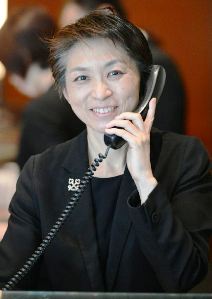 笑顔で電話応対するグランドハイアット東京チーフコンシェルジュの阿部佳さん＝東京・六本木で