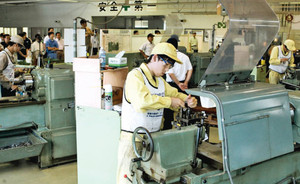 真剣な表情で旋盤作業に取り組む生徒たち＝名古屋市北区の名古屋高等技術専門校で