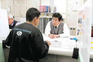 窓口を訪れて相談員の対応を受ける外国人男性＝ハローワーク四日市で